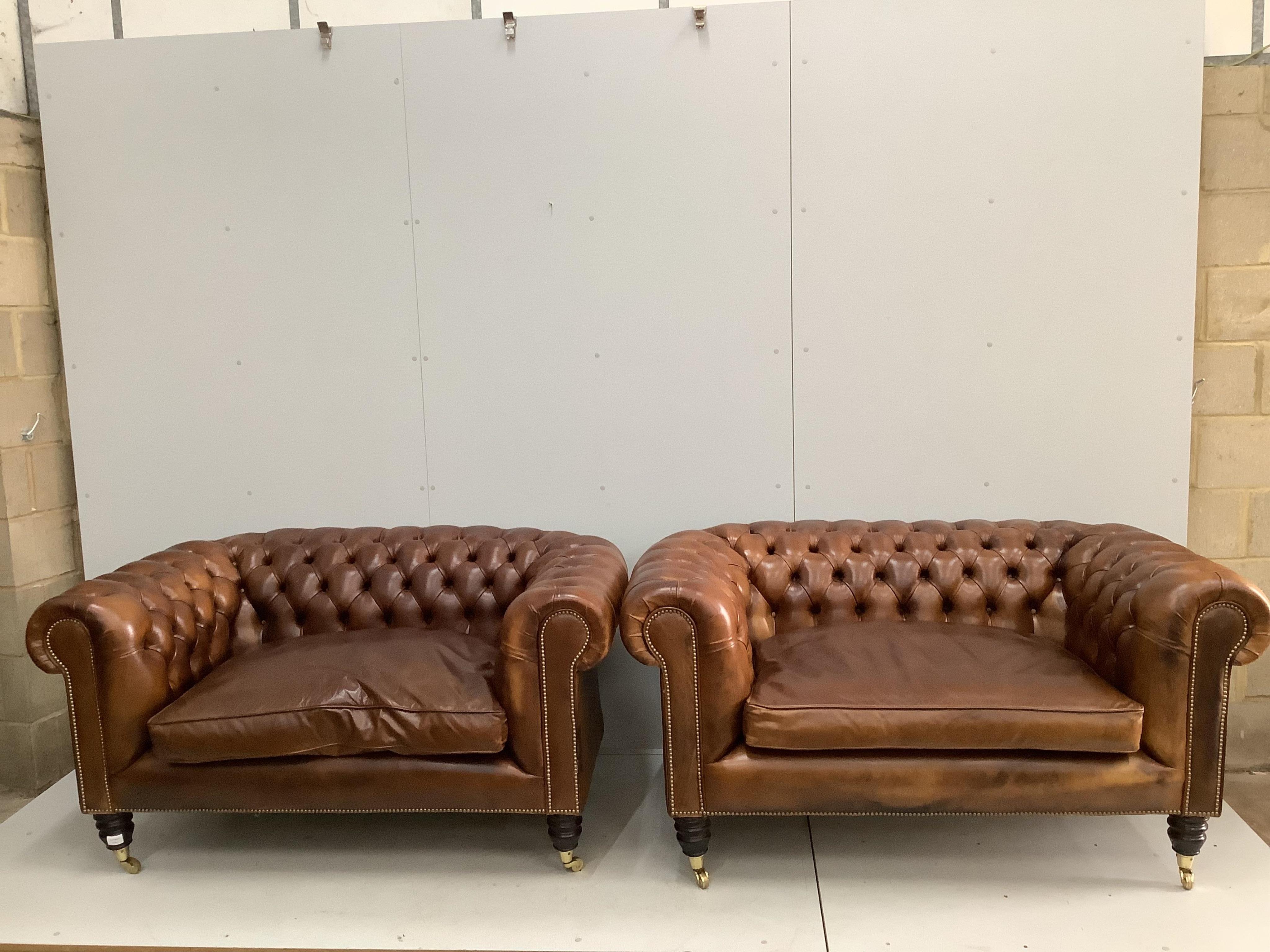 A pair of modern Victorian style buttoned tan leather small Chesterfield settees, width 154cm, depth 88cm, height 78cm. Condition - good